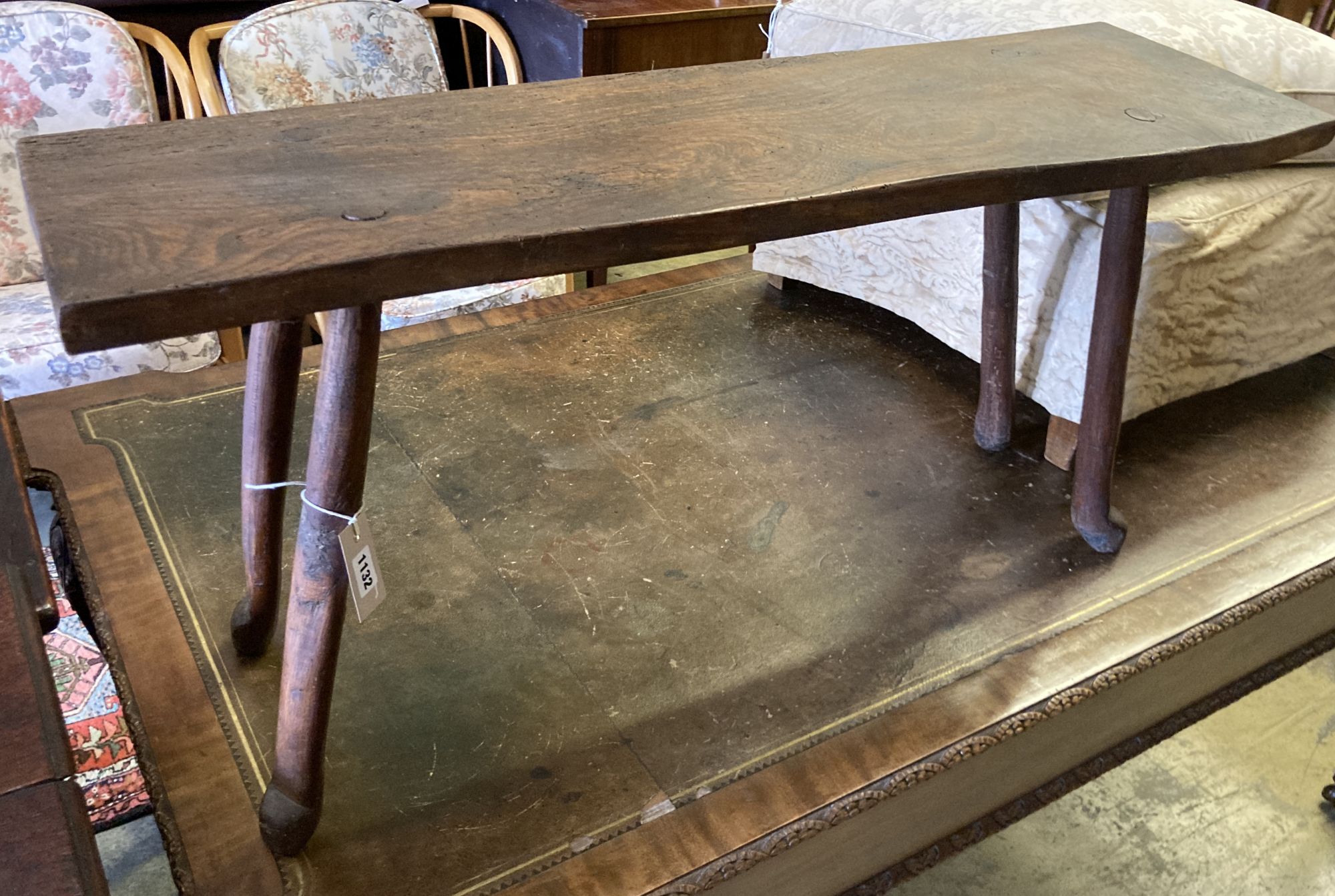 A small 19th century elm bench, on pegged legs, length 101cm, depth 30cm, height 49cm